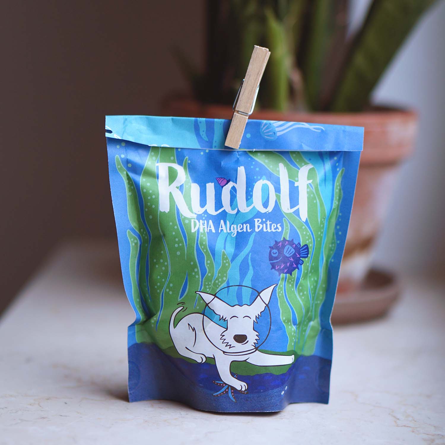 Vegan4Dogs Rudolf DHA Algae Bites, securely closed with a clothespin for lasting freshness and daily DHA supply.